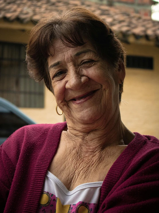 a woman with her eyes closed in front of a house