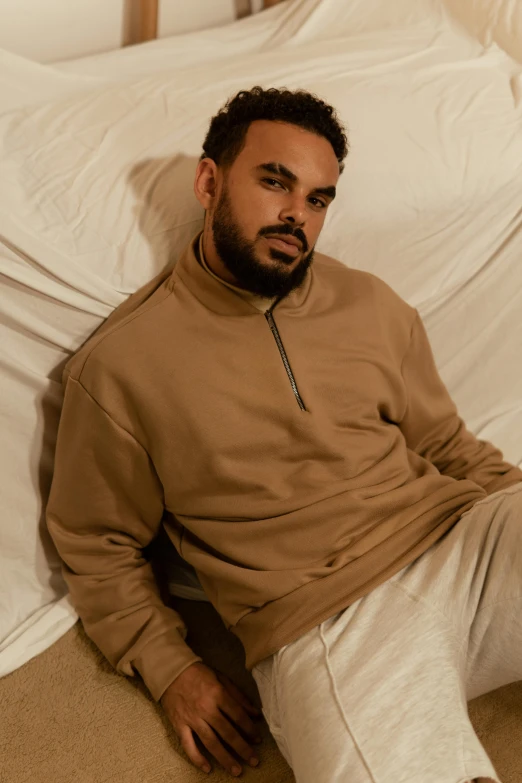 a man wearing sweat pants and a sweater