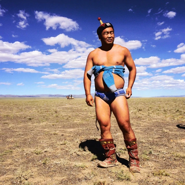 a man in a native - american costume standing in an open field