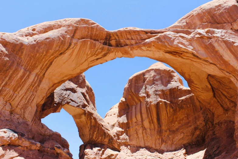 rock formations stand in the background as one looks at the sky