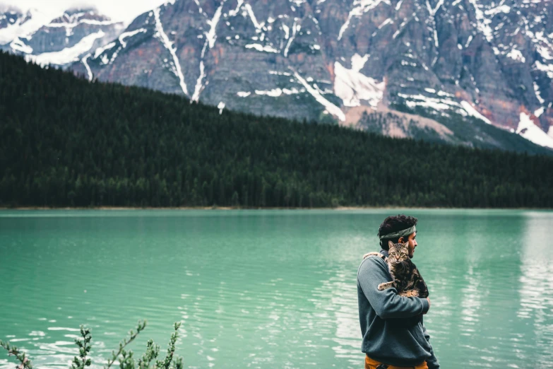 a person standing next to a body of water