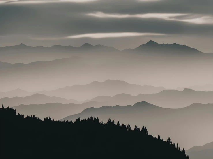 mountain range at dusk, with dark clouds overhead