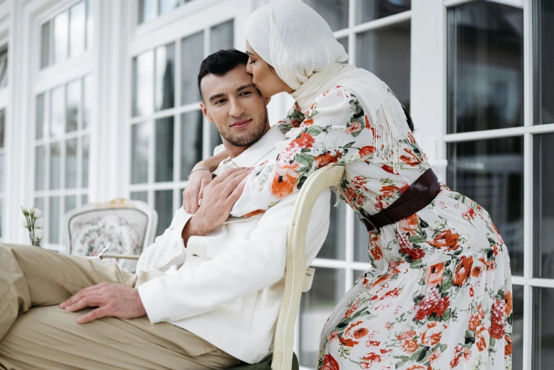 the man is holding a woman with his arms around her