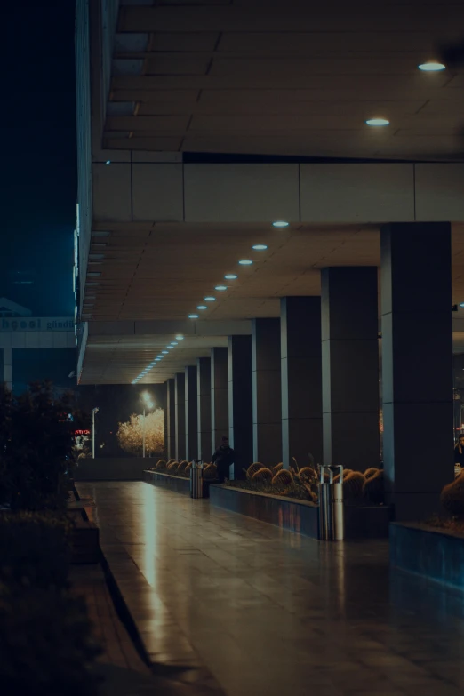 a long empty walkway in an underground parking area