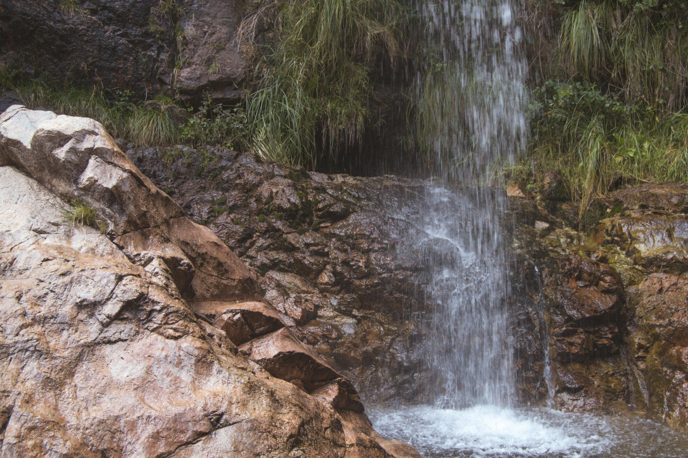 the large waterfall has lots of water coming out of it