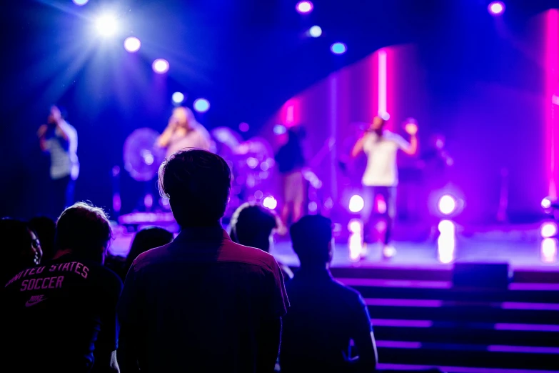 a man speaking to a group of people on stage