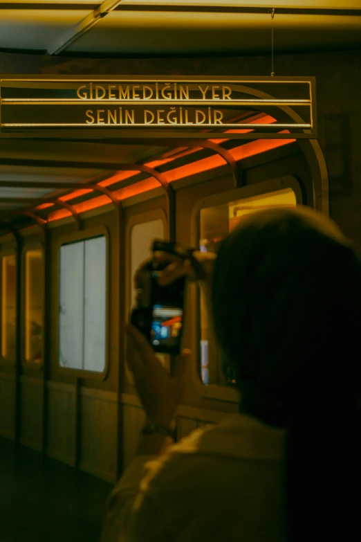 a woman taking a picture on a subway