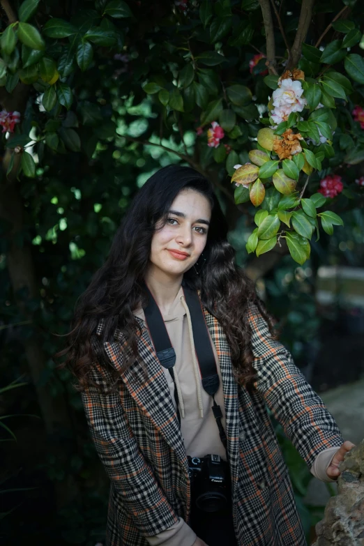 a woman is posing for the camera holding her camera