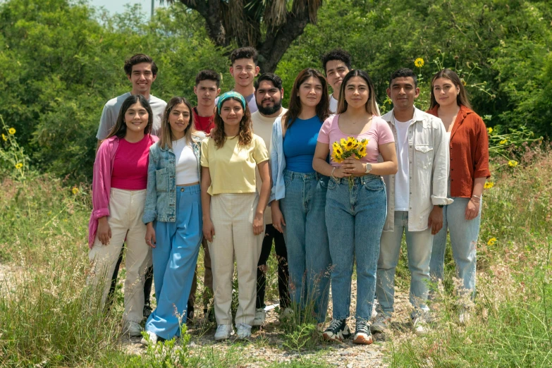 a group of s are posing in a field