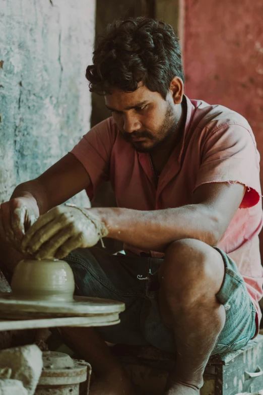 the young person is working on a piece of pottery