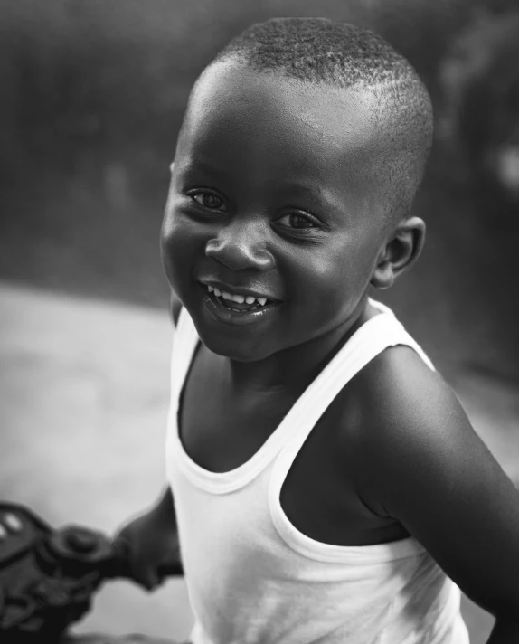 a black - and - white po of a smiling child