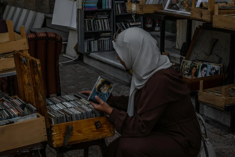 the person is sitting on the chair and holding a magazine