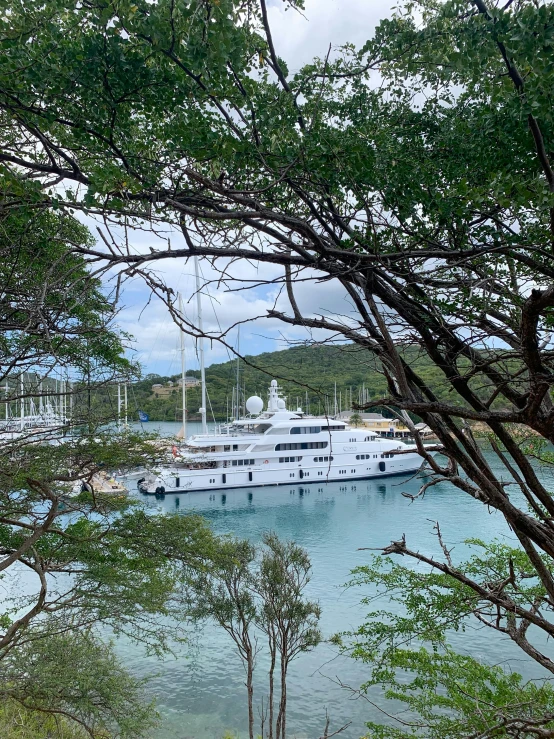 a large yacht sailing in the water with other boats