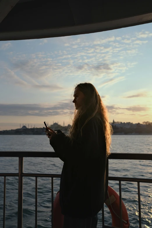 a woman standing next to the ocean on a sunny day