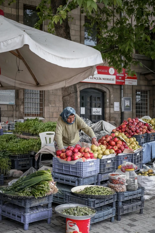 the person is working in a produce stand