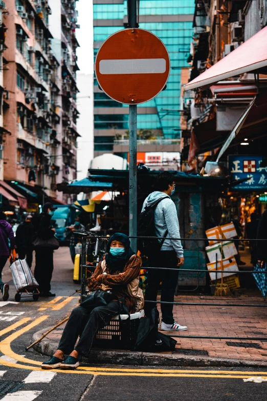 a couple of people standing on the side of a street