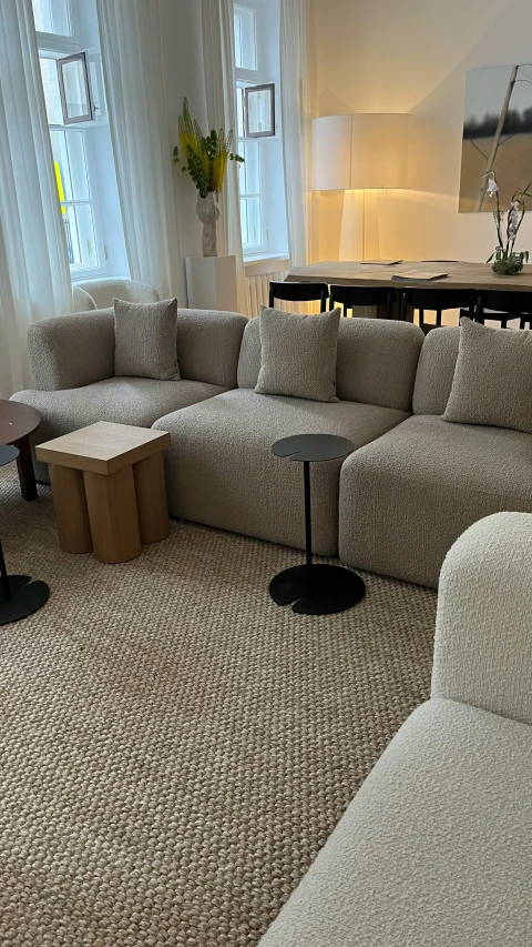 the modern living room has two tables and four couches