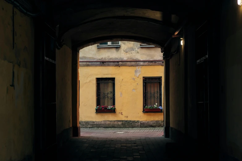 an archway that is leading to two windows