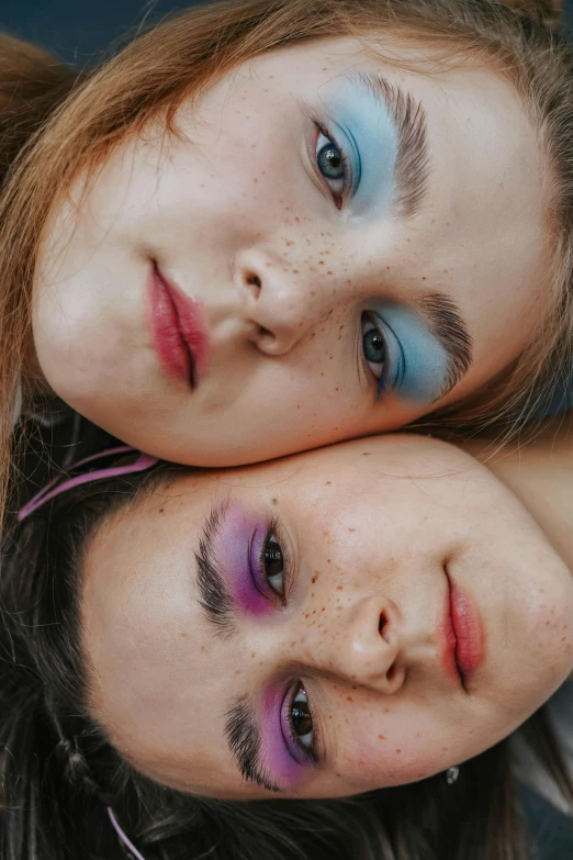 two s with red, white and blue makeup look as if laying down