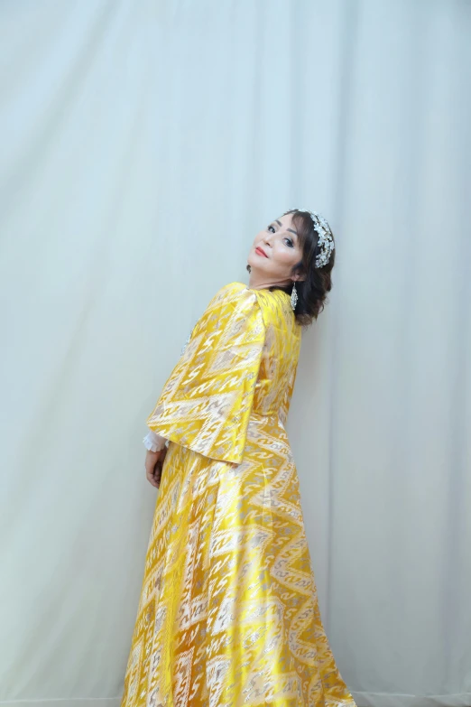 an african american woman wearing a yellow dress