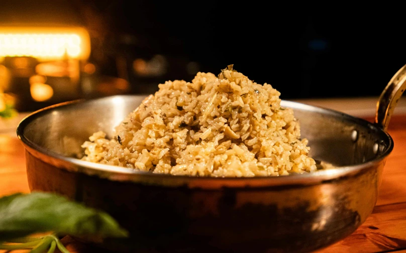 a bowl filled with a little grained mixture on top of a wooden table