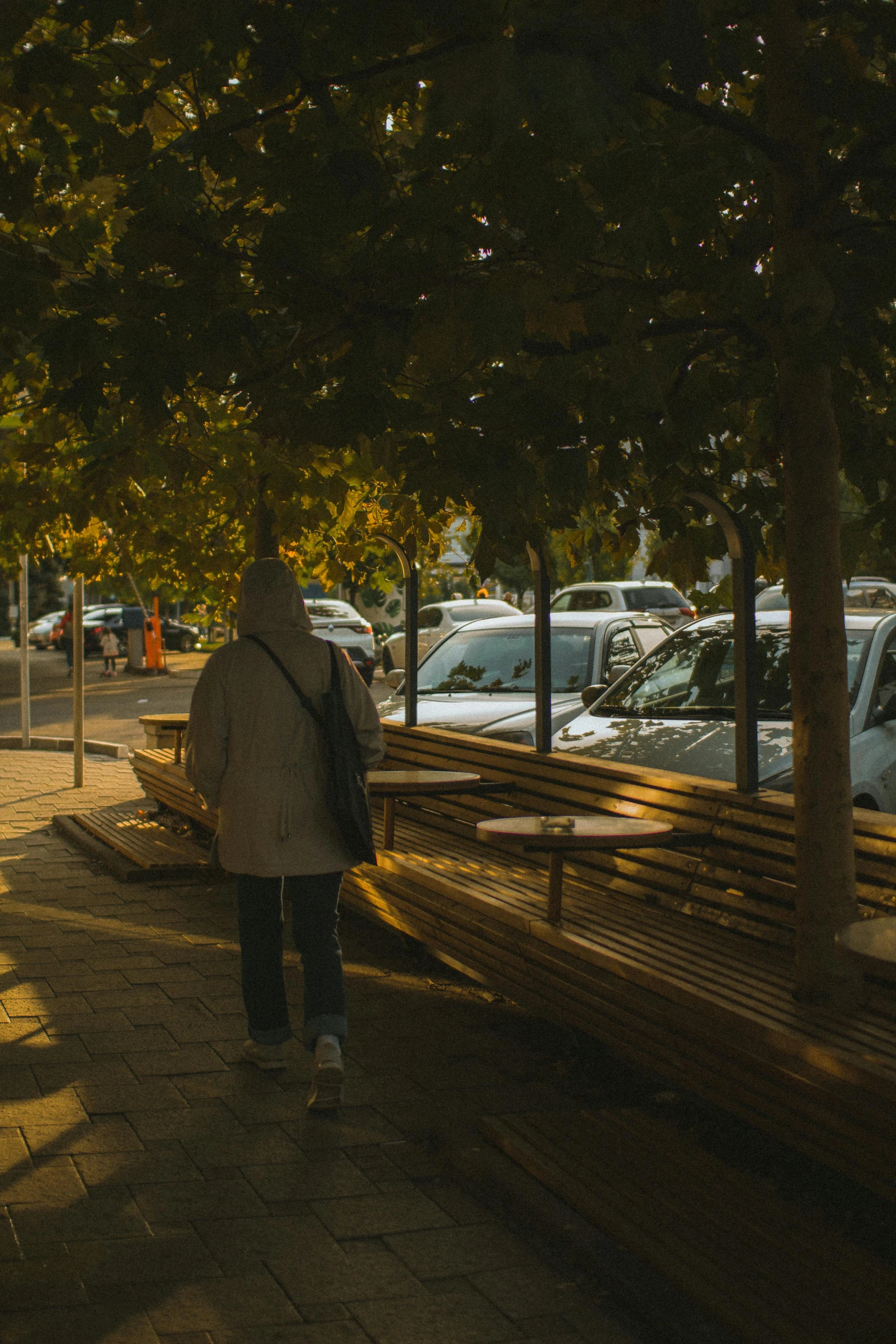 someone is walking in front of many parked cars