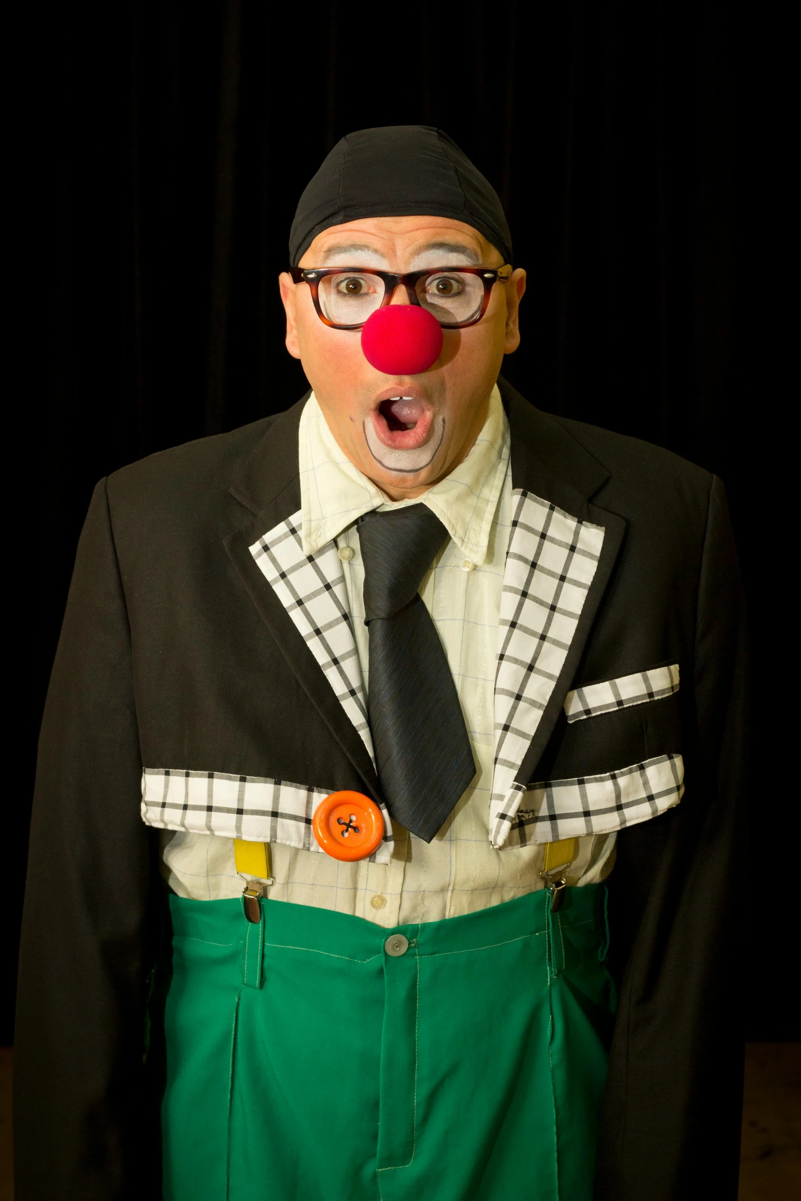 a man in a hat and tie wearing clown wigs