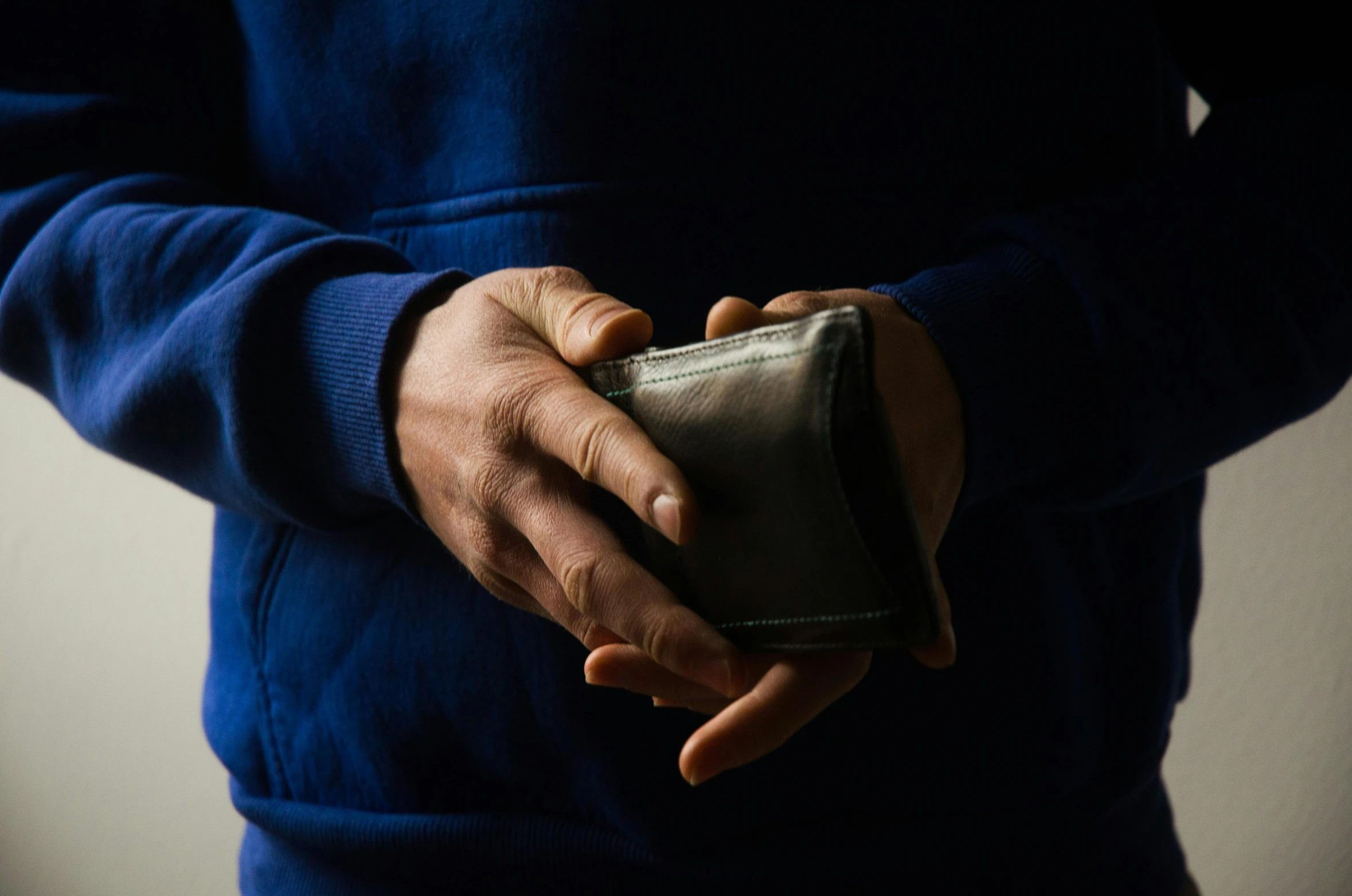 an older person holding a purse in their hands