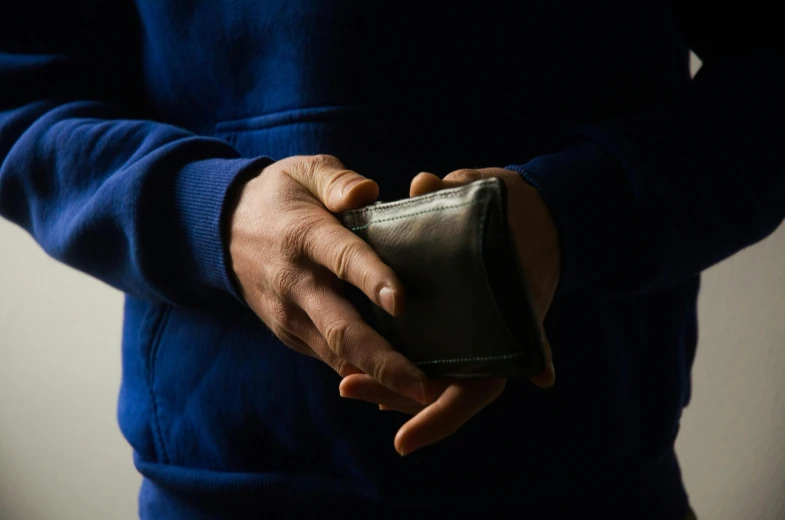 an older person holding a purse in their hands