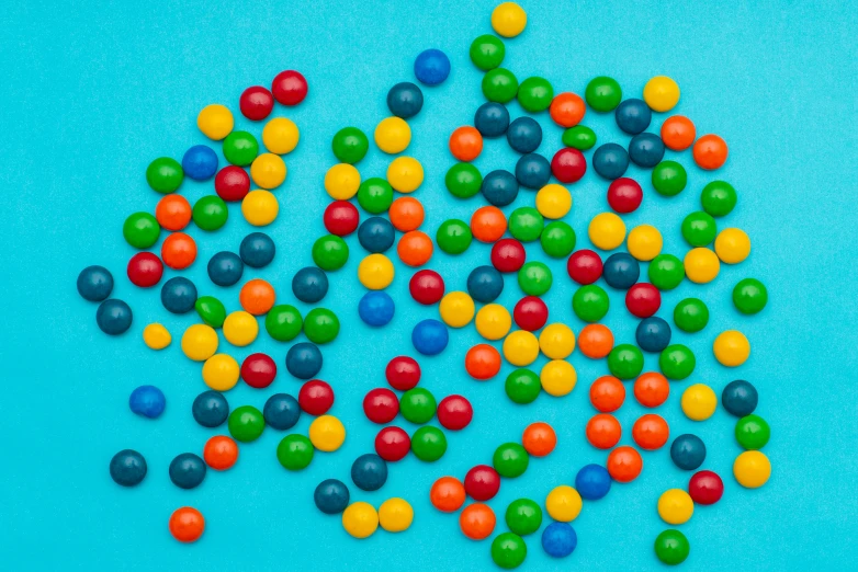 colorful candies scattered together on a blue surface