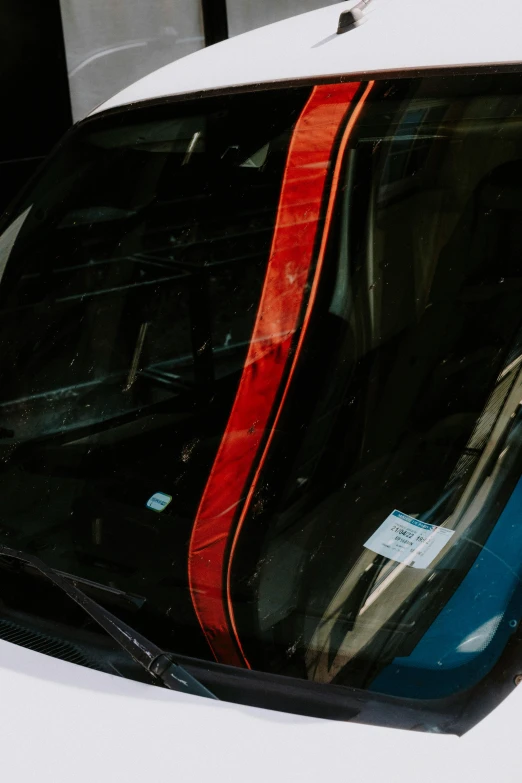 a close up of a car with a red strip