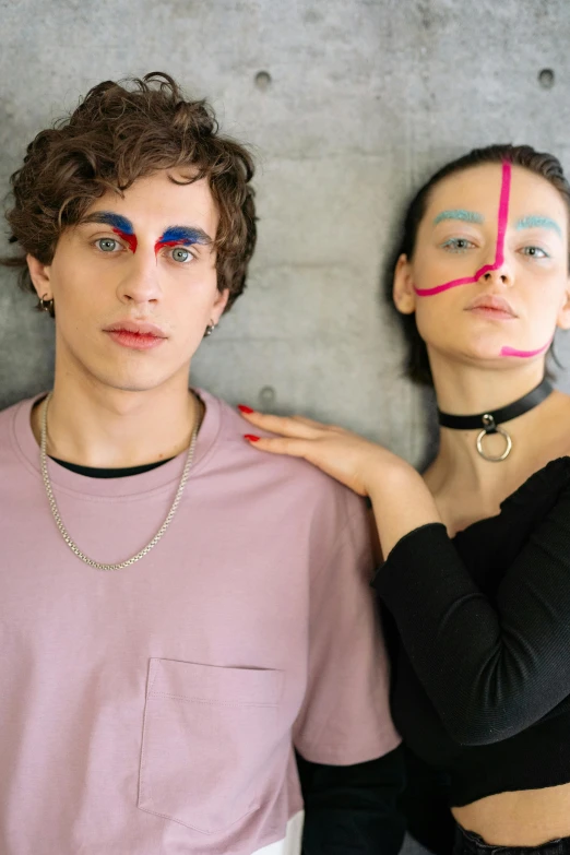 two people with makeup on their faces and one wearing a choker