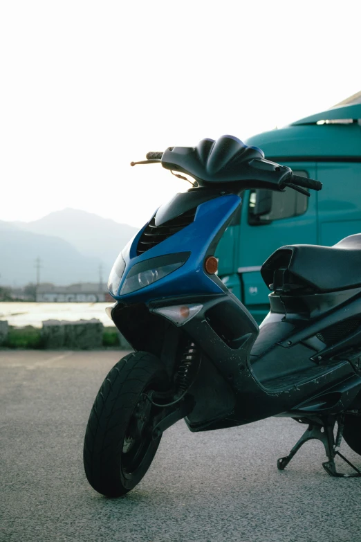 a blue motorcycle is parked on the side of the road