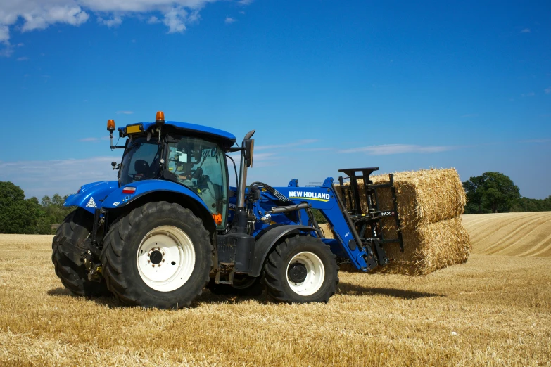 a tractor is driving through a wheat field