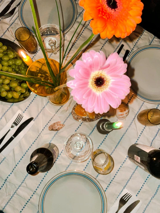 a table topped with a white plate covered in pink flowers