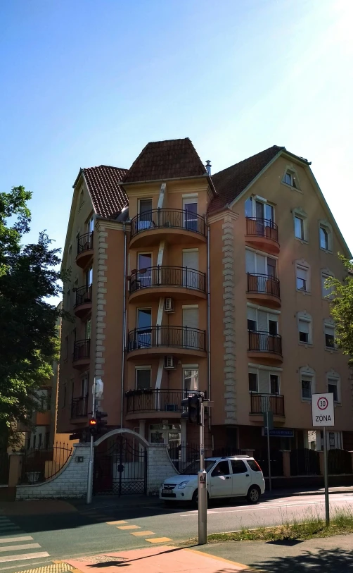 a tall orange building sitting next to a street