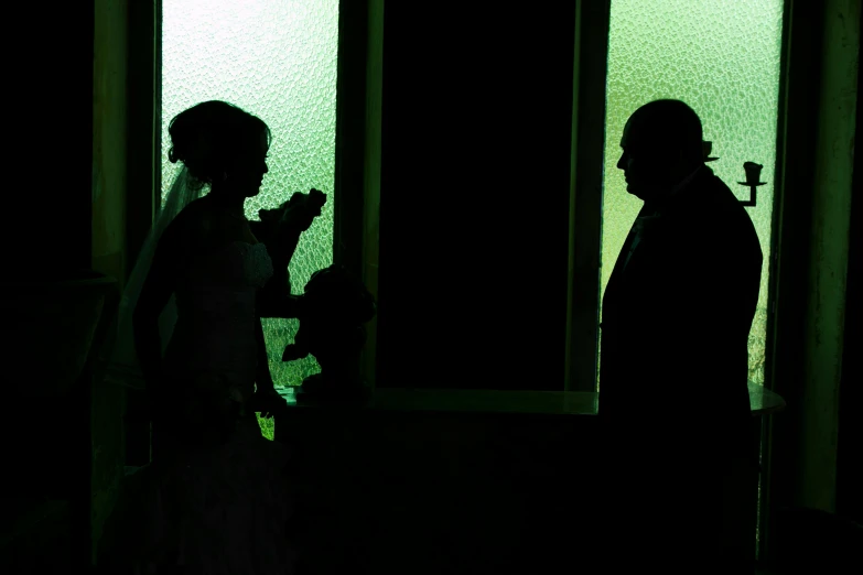 a couple walking to their wedding ceremony in the dark