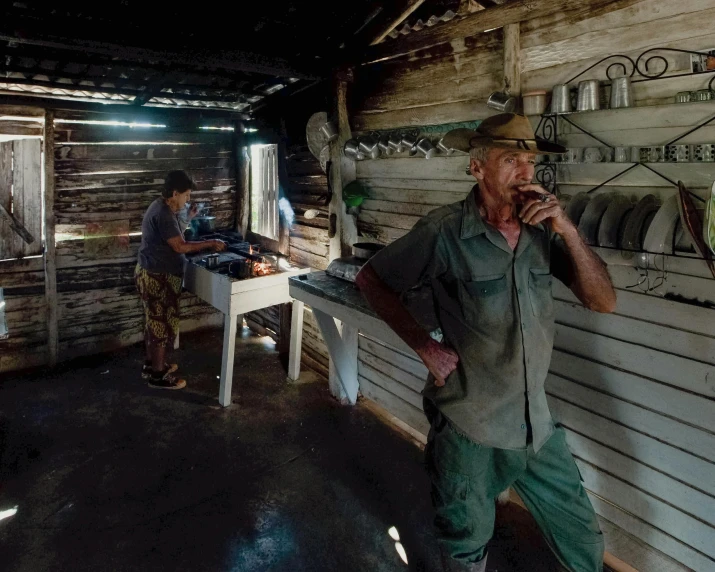 a man walking into a shack holding a knife