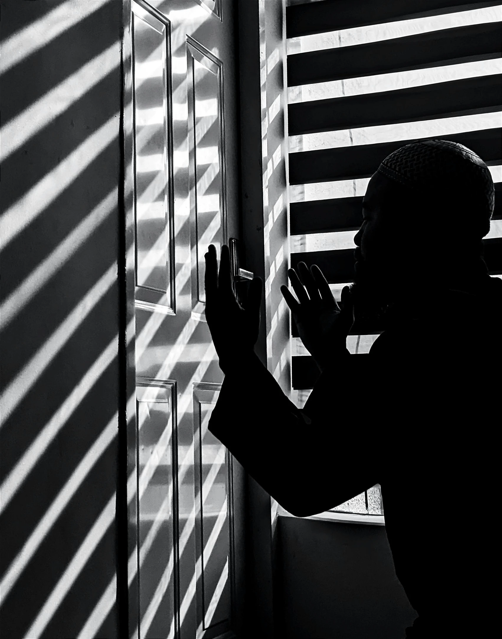 a silhouette of a person in front of a window