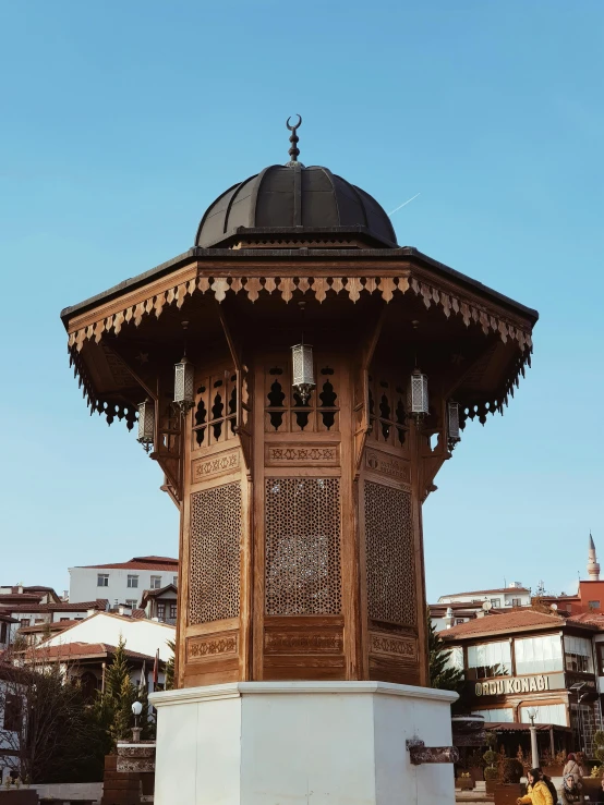 wooden dome shaped building with intricate designs at the top