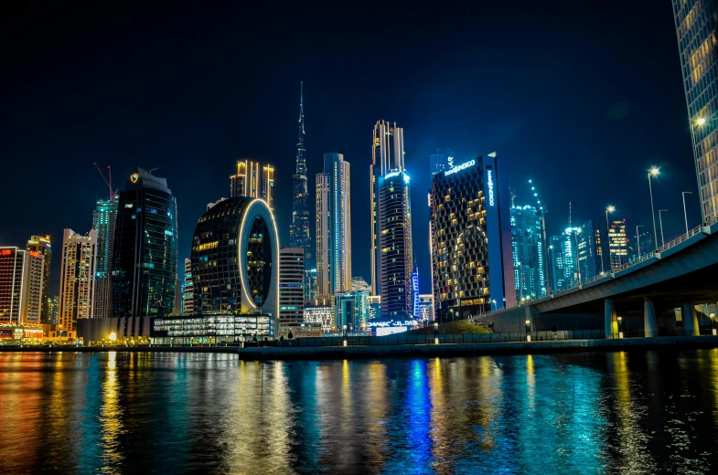 the lights of a city are reflected in the water