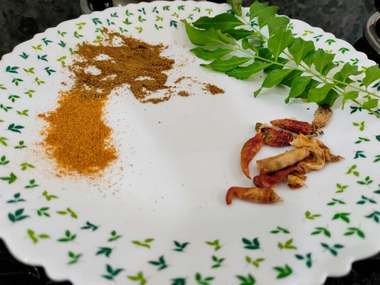 a plate with different spices and herbs on it