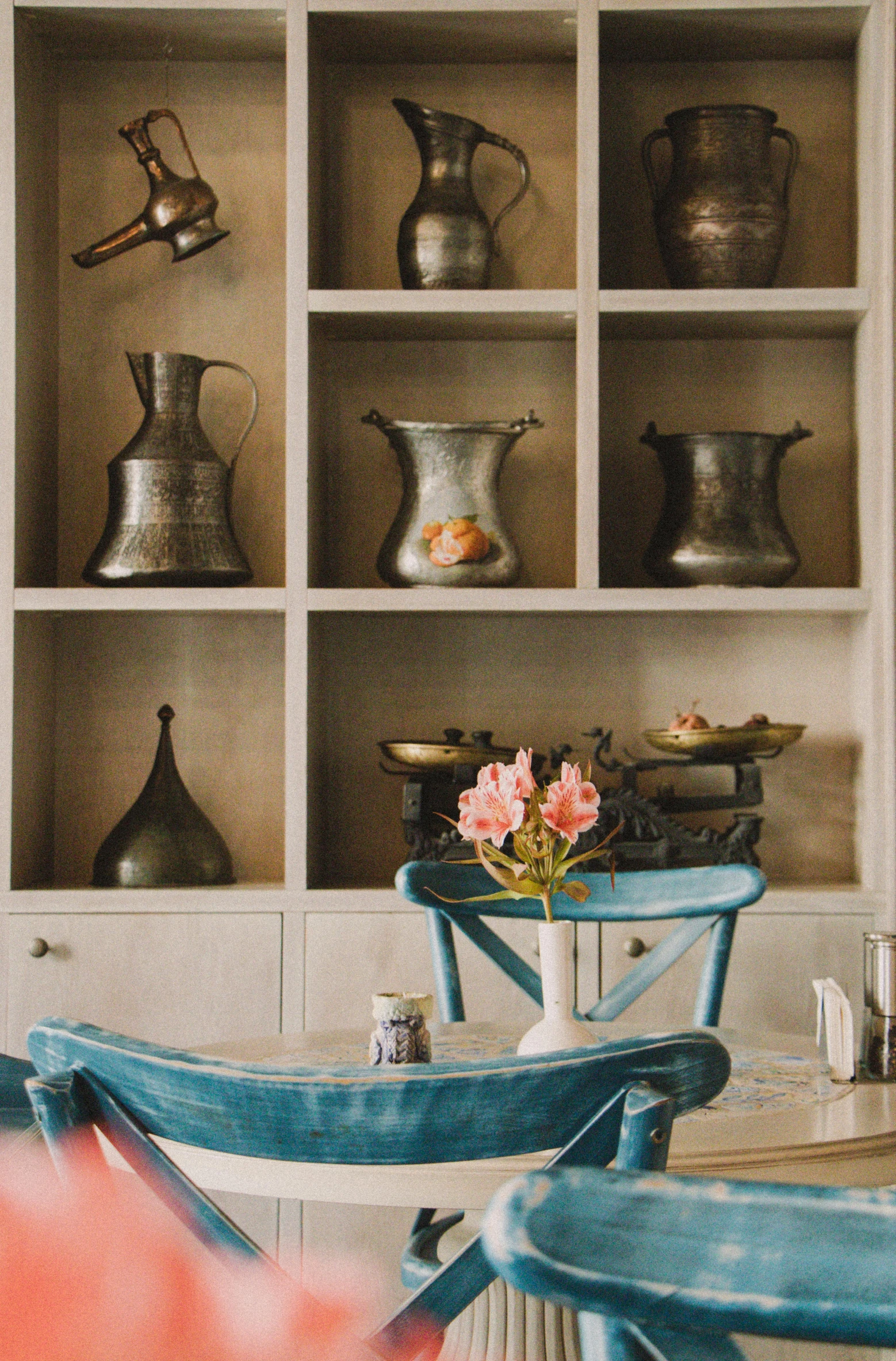 a bunch of vases are seen above a small table