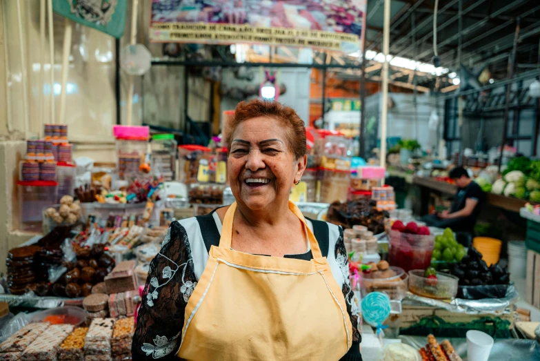 the owner of an outdoor market stands near the open air