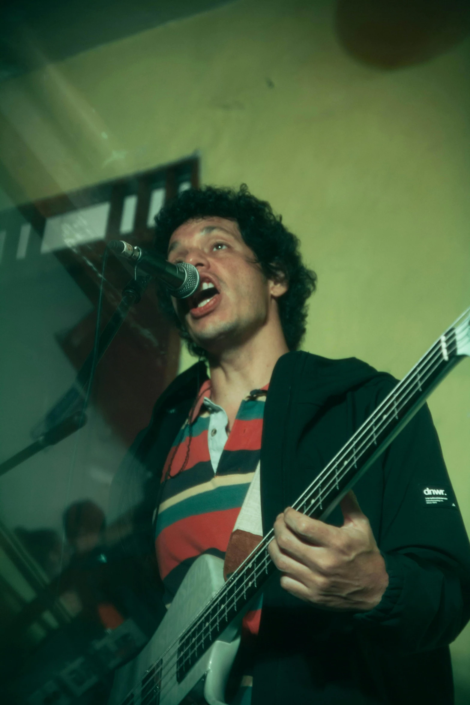 a man with his mouth open holding a bass