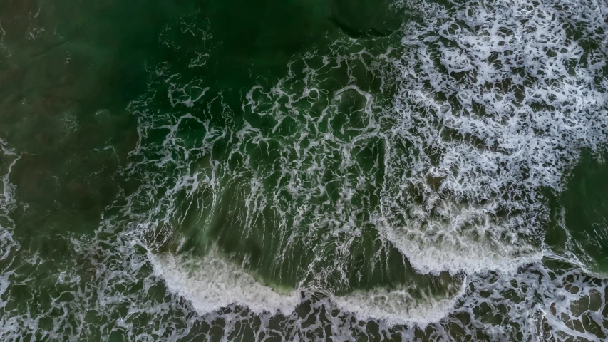 aerial view of green ocean with rough waves