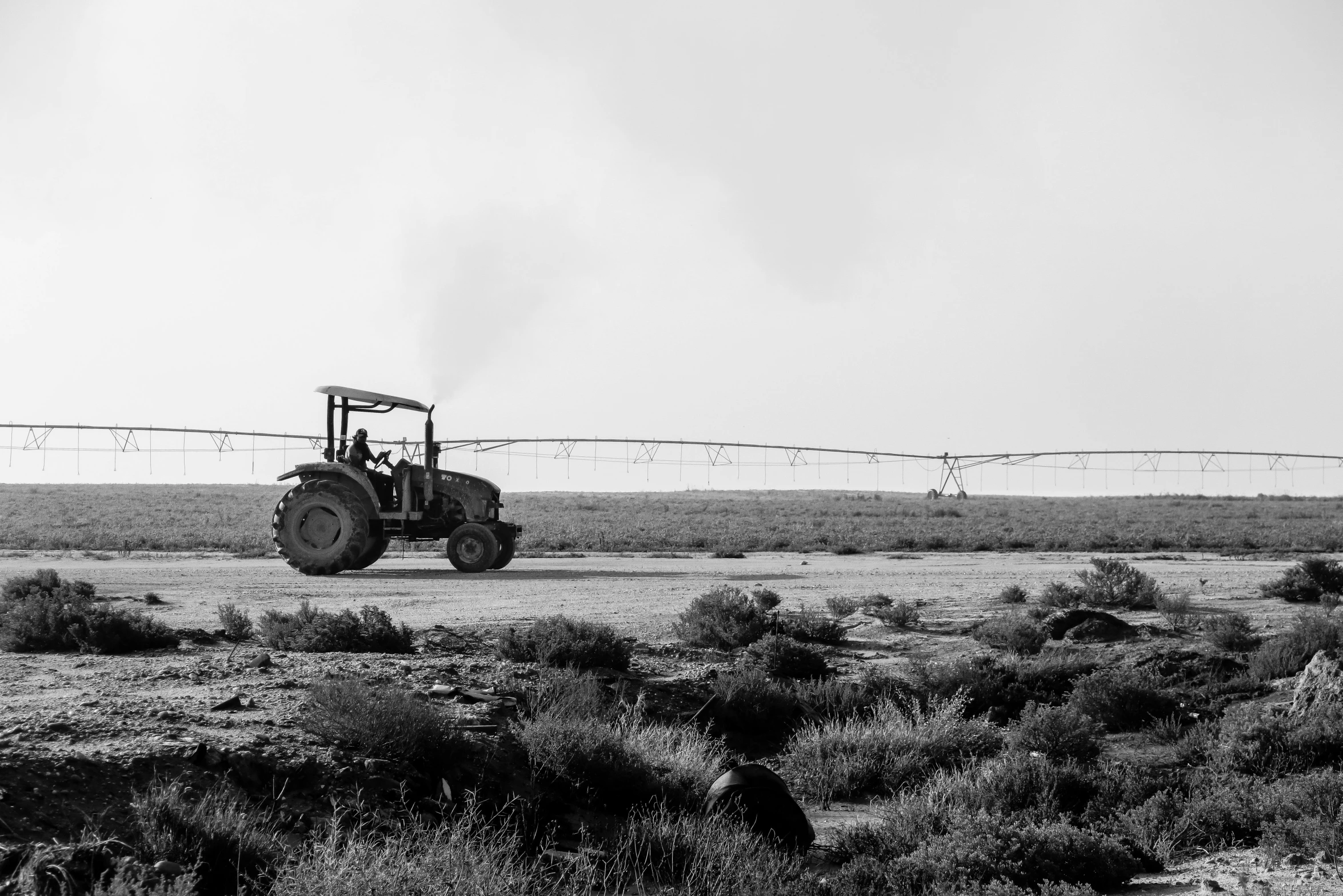 a black and white po of a tractor pulling a trailer