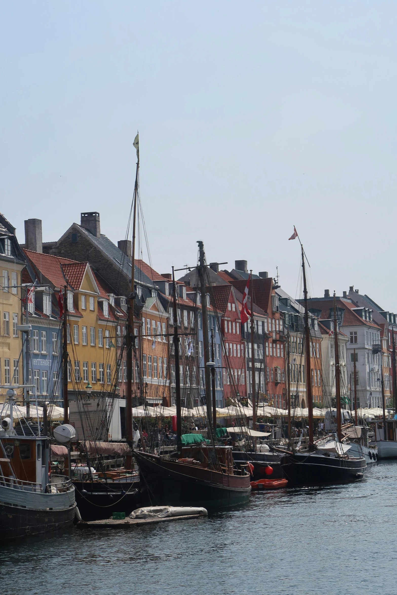 there are many boats in the harbor near some buildings