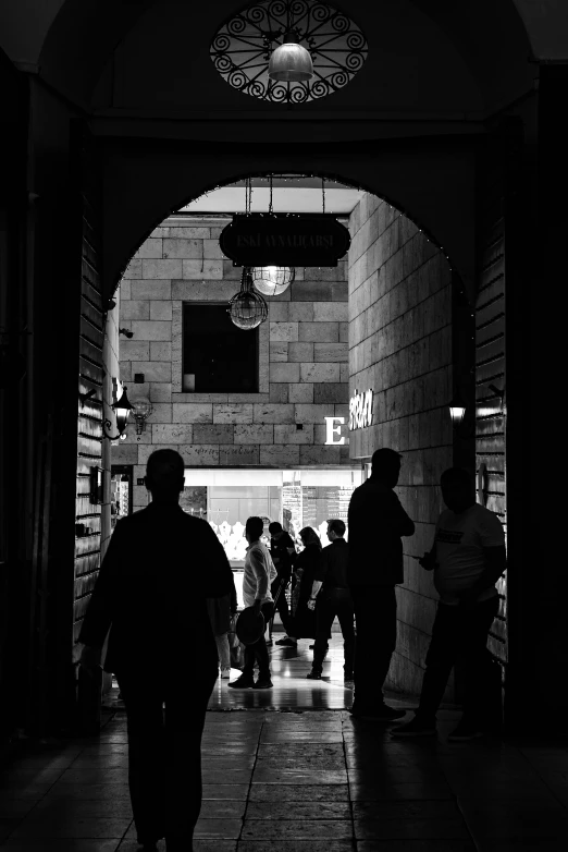 several people are walking through an archway