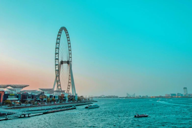 a very big wheel in the sky over a harbor